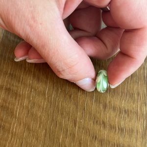Green and white glass charm